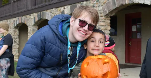 Campers and staff carving pumpkins